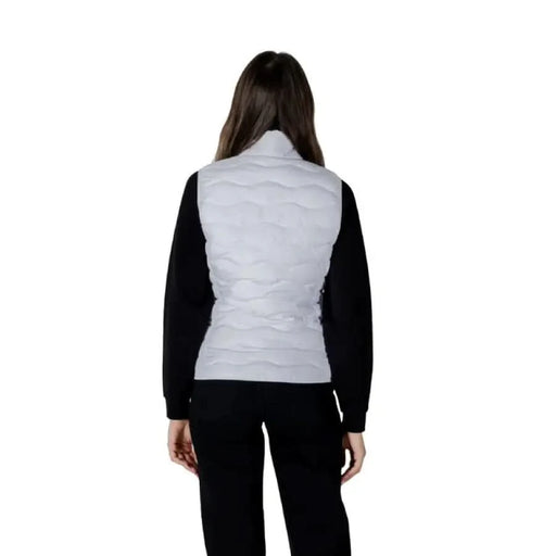 Woman in gray puffer vest and black pants showcasing EA7 Women’s Sleeveless Turtleneck Jacket
