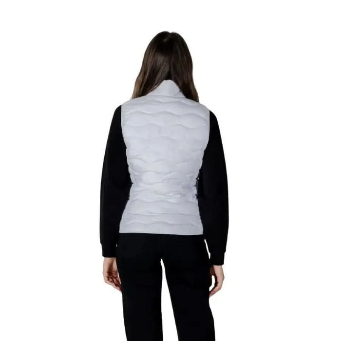 Woman in gray puffer vest and black pants showcasing EA7 Women’s Sleeveless Turtleneck Jacket