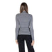 Woman in gray turtleneck and black pants wearing Morgan De Toi Women’s Grey Turtleneck Sweater