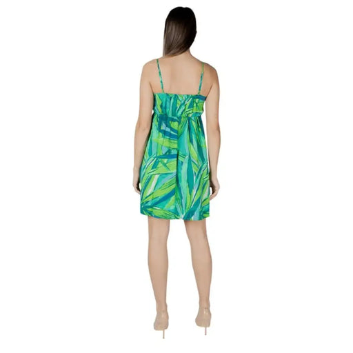 Woman wearing a green and blue patterned sundress for the Green Blue Patterned Sundress product