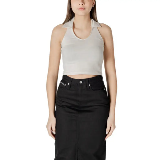 Woman wearing a peach halter top and black skirt displaying Womens Peach Halter Top and Black Skirt
