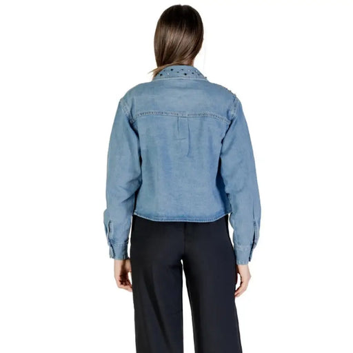 Woman wearing a Light Blue Embellished Denim Jacket and black pants