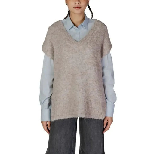 Woman in light blue shirt and beige knit vest styled in Vero Moda Low-Cut V-Neck Sweater