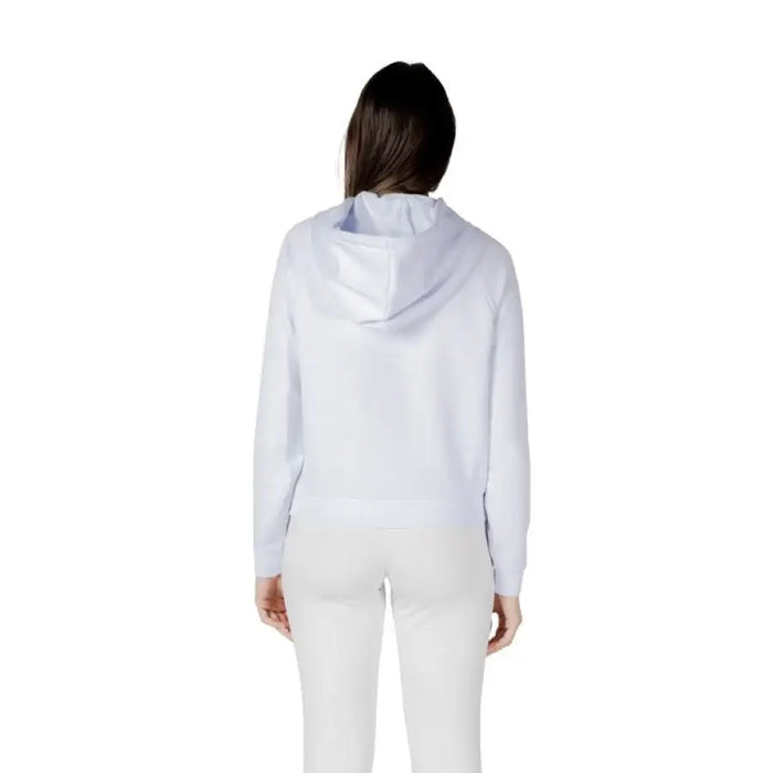 Woman wearing a light blue hoodie and white leggings in a White Hooded Sweatshirt and Leggings Set