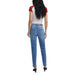 Woman wearing light blue denim jeans and a white T shirt with red sleeves