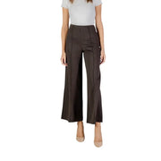 Woman wearing light-colored top and dark green pinstripe cropped trousers