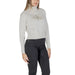 Woman wearing a light gray turtleneck sweater and black jeans for the women’s light gray turtleneck sweater product