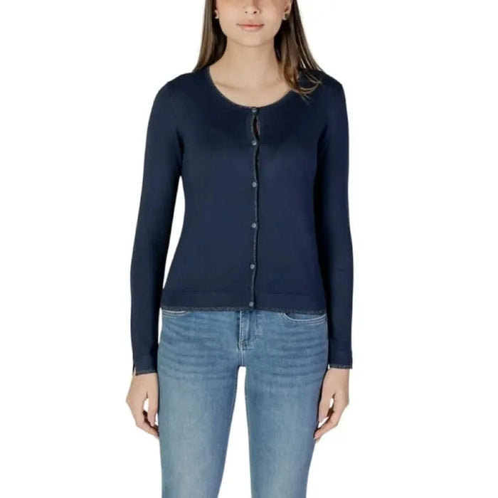 Woman modeling a Liu Jo white long cardigan with a navy cardigan and jeans