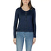 Woman modeling a Liu Jo white long cardigan with a navy cardigan and jeans
