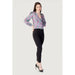 Woman models Rinascimento Women’s Green V-Neck Printed Blouse with black pants