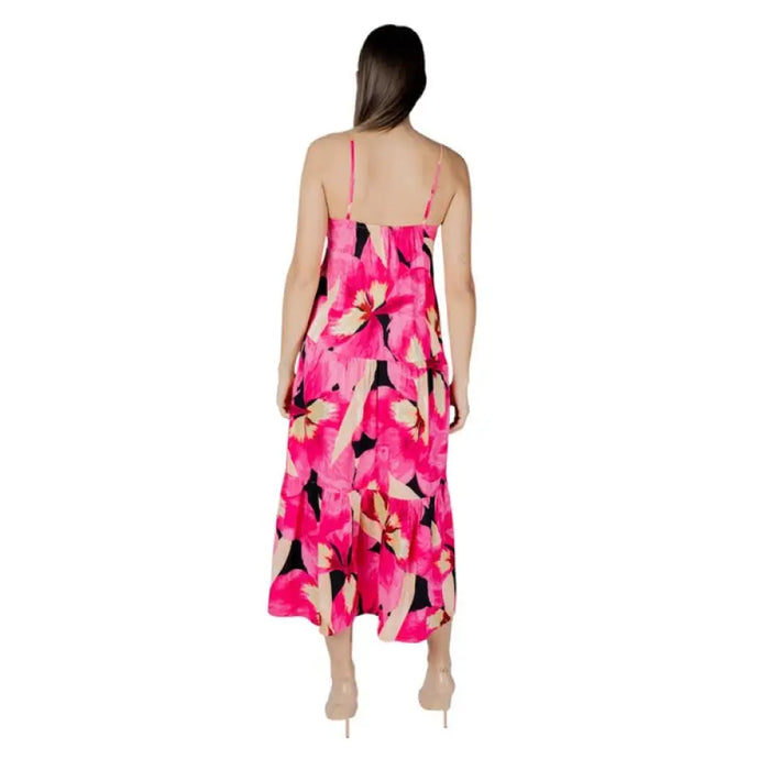 Woman wearing a Pink Floral Tiered Maxi Dress with a floral pattern and flowing design