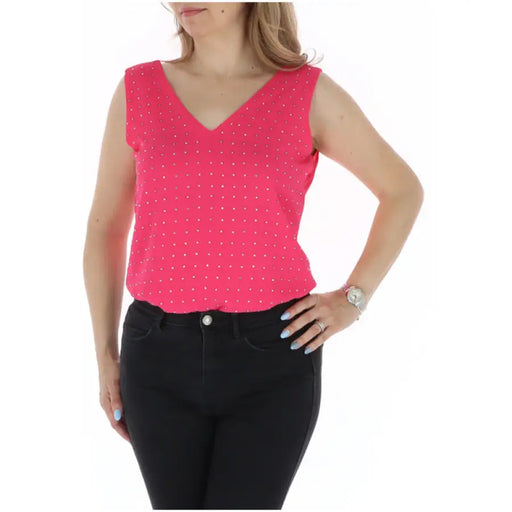 Woman wearing a pink polka dot sleeveless top and black pants for the Pink Polka Dot Sleeveless Top and Black Pants product
