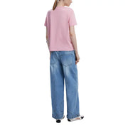 Woman in pink T-shirt and wide-leg blue jeans for Desigual Women Pink Spring Summer collection
