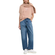 Woman wearing a pink T-shirt and blue denim jeans from Women Casual Denim Jeans and T Shirt Collection