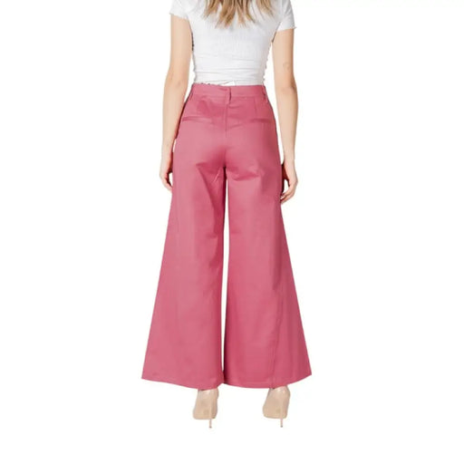 Woman modeling stylish Pink Wide Leg Trousers with a vibrant pink hue