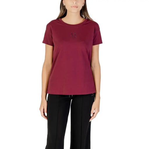 Woman wearing dark red Armani Exchange cotton T-shirt with sparkly chest embellishment