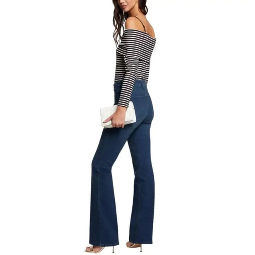 Woman in striped top and flared jeans wearing Morgan De Toi Black Knit Sweater
