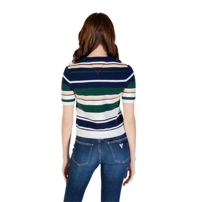 Woman wearing a striped short-sleeved sweater and blue jeans for the product display