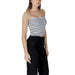 Woman wearing a striped tube top and black pants showcasing stylish casual attire