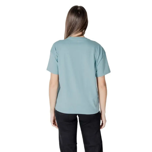 Woman in teal T shirt and black pants representing Women Light Blue T Shirt product