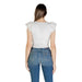 Woman wearing a white top and blue jeans displayed in White Top and Blue Jeans for Women product