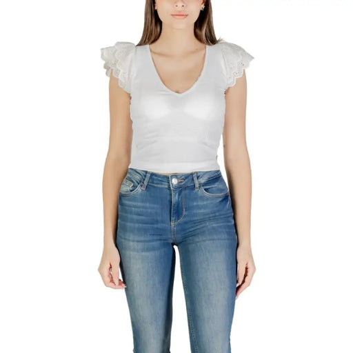 Woman wearing a white top and blue jeans for women in product photograph