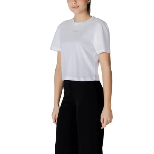 Woman wearing a white crop top and black pants from Women’s White T Shirt and Black Pants collection