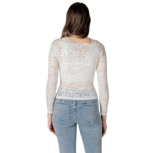 Woman wearing a white lace long sleeve top and blue jeans showcasing Women’s White Lace Long Sleeve Top