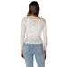 Woman wearing a white lace long sleeve top and blue jeans showcasing Women’s White Lace Long Sleeve Top