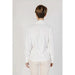 Woman in white shirt and light pants modeling Rinascimento Women’s White V-Neck Long Blouse