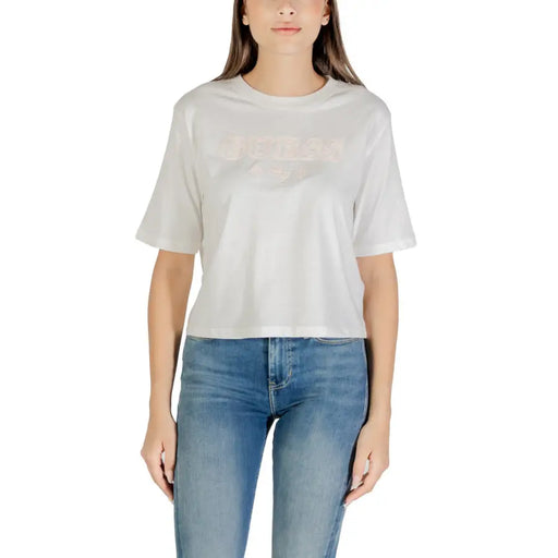Woman wearing Guess Active White Printed Cotton Round Neck T Shirt and light blue denim jeans