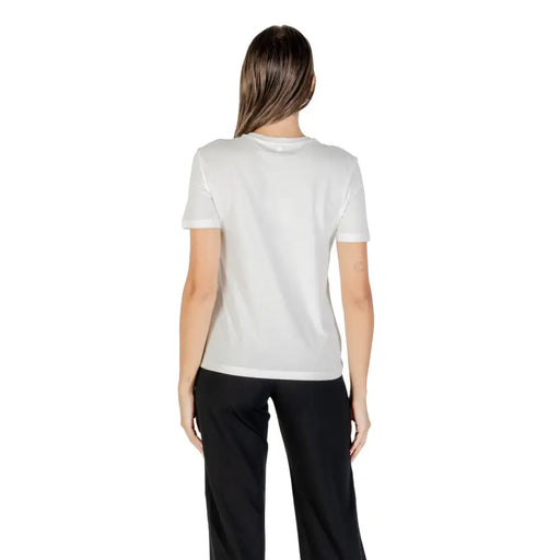Woman wearing a white printed short sleeve round neck T shirt for women
