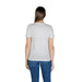 Woman wearing a white graphic tee and jeans showcasing casual fashion style