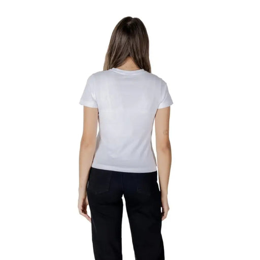 Woman wearing a white short sleeve T-shirt and black pants for the product White T-Shirt with Short Sleeves