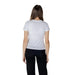 Woman wearing a white short sleeve T-shirt and black pants for the product White T-Shirt with Short Sleeves