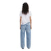 Woman wearing white T shirt with colorful face graphic and light blue jeans