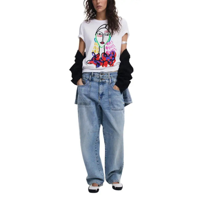 Woman wearing a white T-shirt with colorful face graphic and light blue jeans