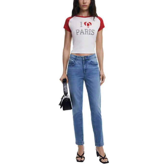 Woman wearing white T shirt with red sleeves and light blue denim jeans