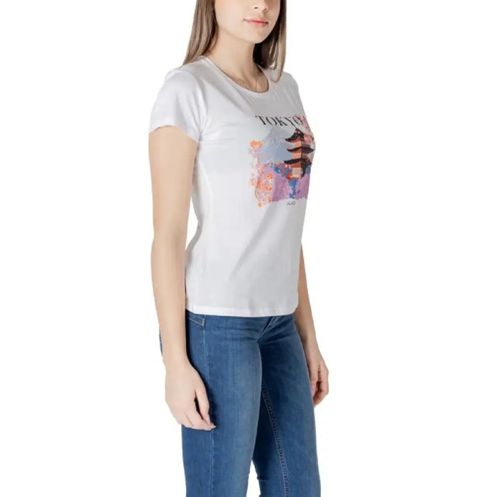 Woman wearing a white T shirt with Tokyo graphic and blue jeans, product display