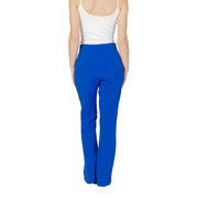 Woman wearing white tank top and bright blue high-waisted trousers for spring and summer