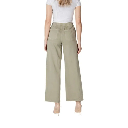 Woman modeling Olive Green Wide Leg Pants in a stylish outdoor setting