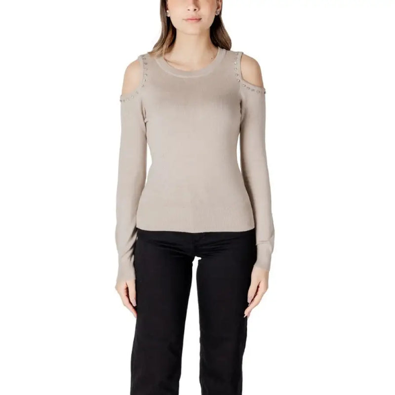 Woman in beige cold shoulder sweater with black pants from Women Cold Shoulder Sweater Collection