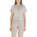 Woman wearing beige linen shirt and pants set, stylish and comfortable for women