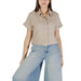 Woman wearing beige linen short-sleeved button-down shirt with wide-leg jeans for women