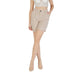 Woman wearing beige high waisted shorts and matching top for a stylish summer look