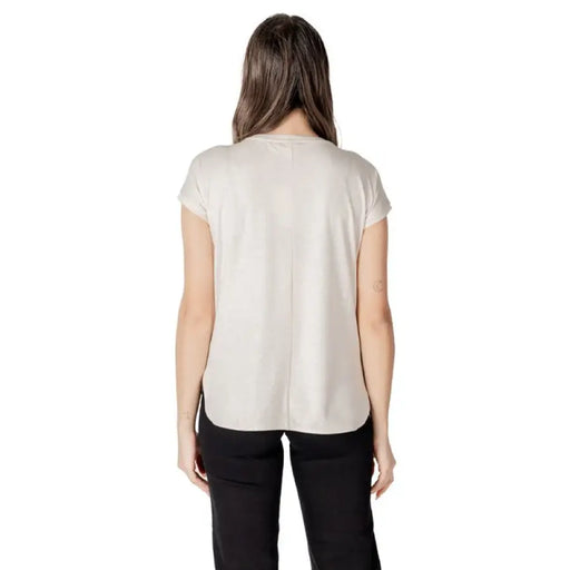 Woman wearing beige T shirt and black pants from Womens Beige T Shirt and Black Pants collection