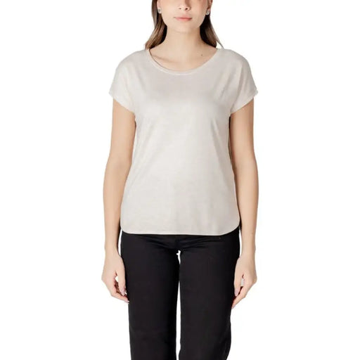 Woman wearing beige T shirt and black pants displayed in Womens Beige T Shirt and Black Pants product image