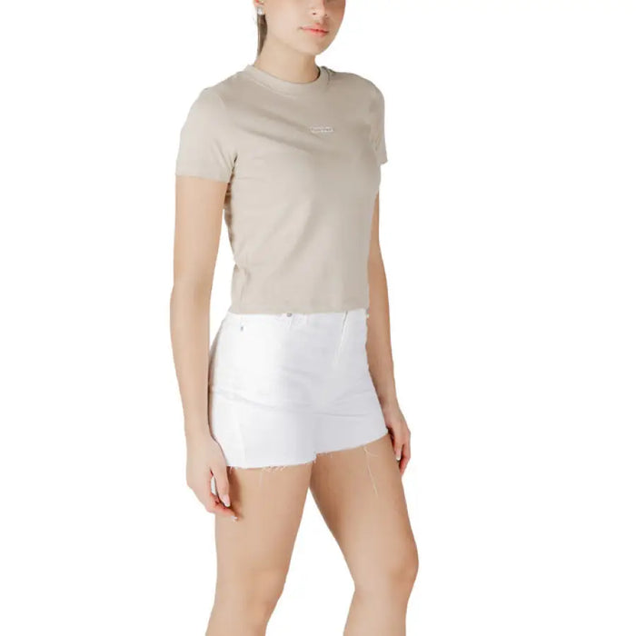Woman wearing a beige T shirt and white denim shorts for the Womens Beige T Shirt and White Denim Shorts product
