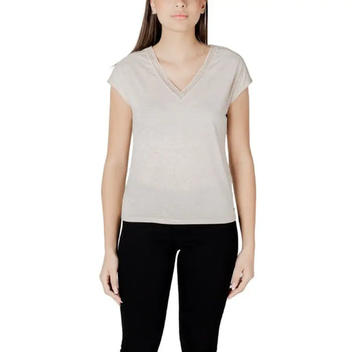 Woman wearing a beige V-neck T-shirt in the Women Beige V Neck T Shirt collection