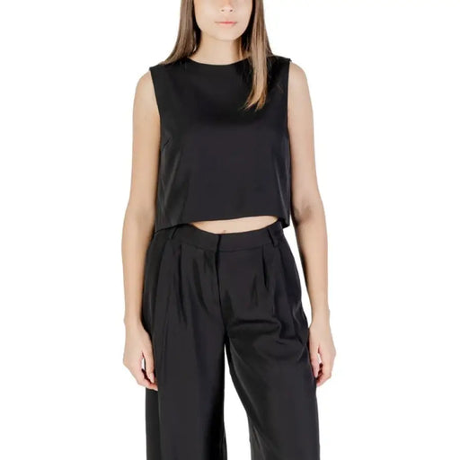 Woman wearing a black crop top and matching pants outfit from Womens Black Crop Top and Pants product line